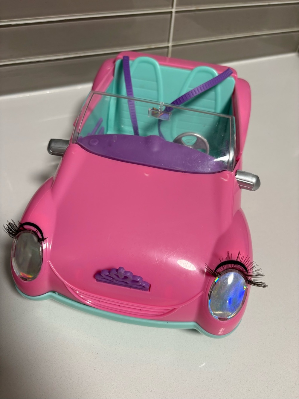 Bright Pink Convertible Toy Car with Teal Interior and Purple Accents